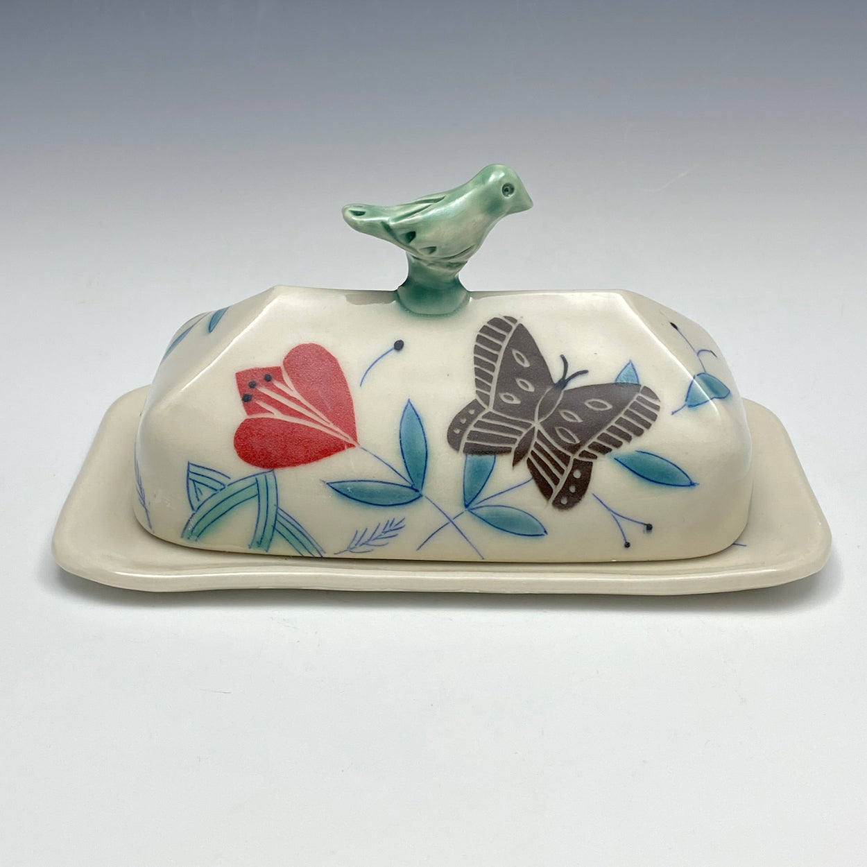 Butter dish with sculpted bird and brown butterflies