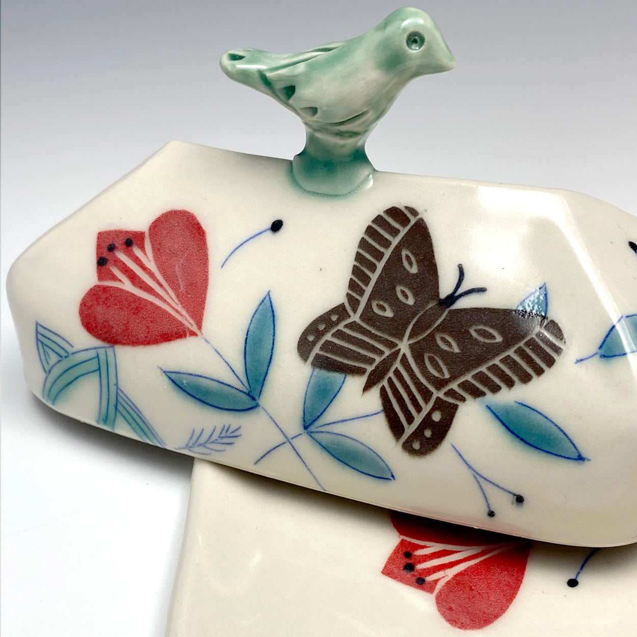 Butter dish with sculpted bird and brown butterflies