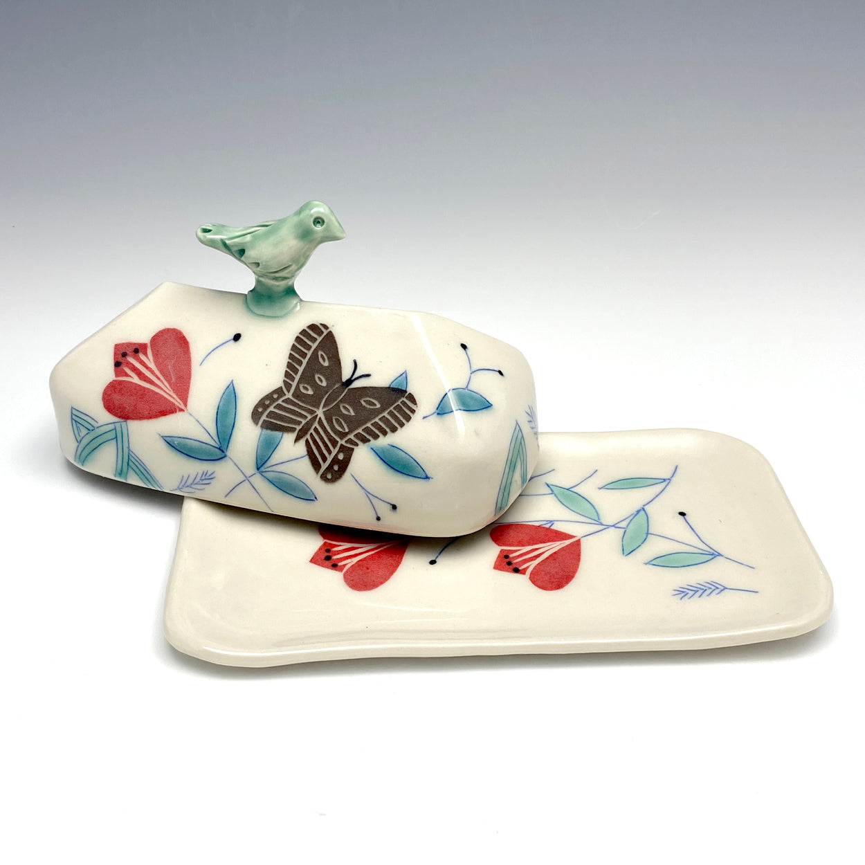 Butter dish with sculpted bird and brown butterflies