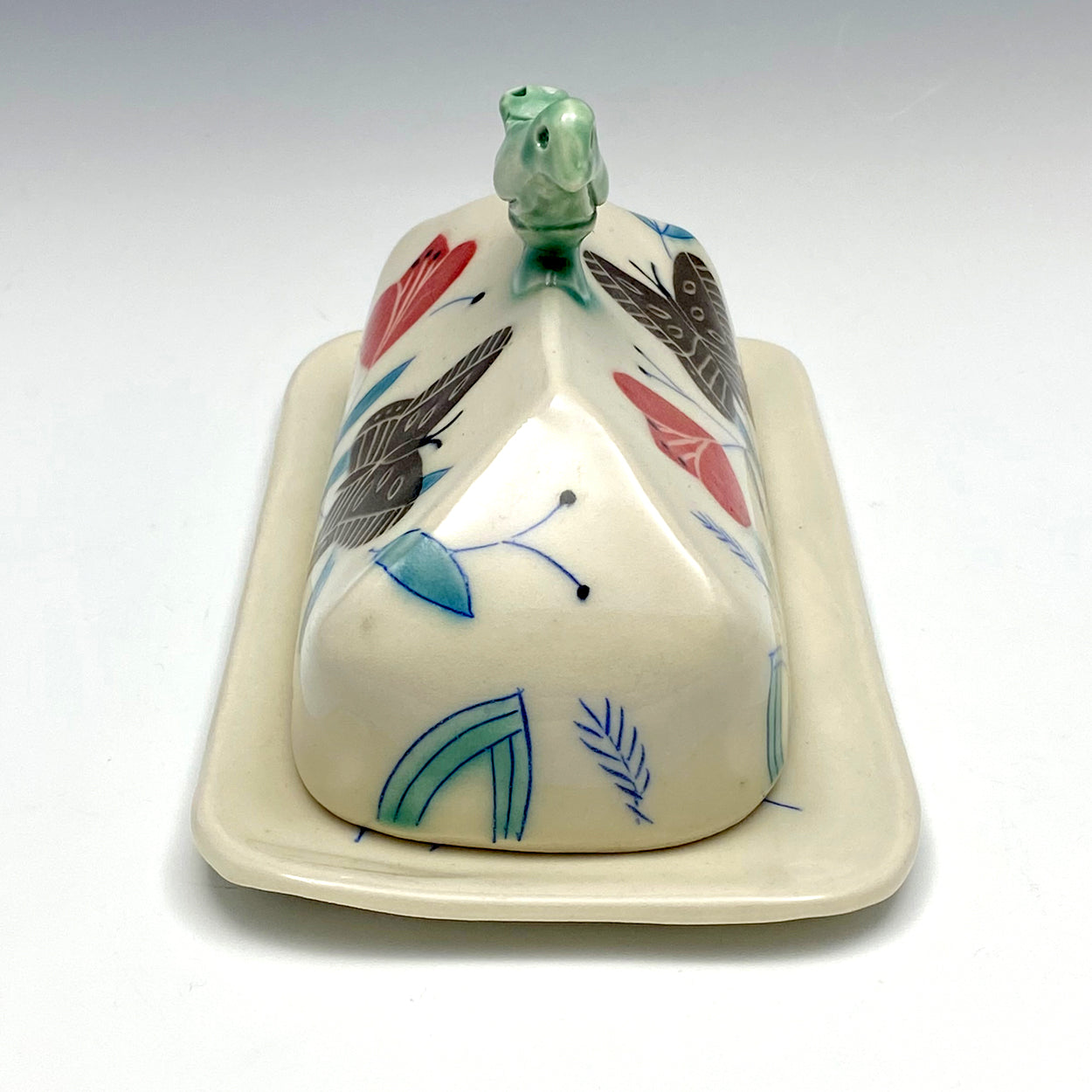 Butter dish with sculpted bird and brown butterflies