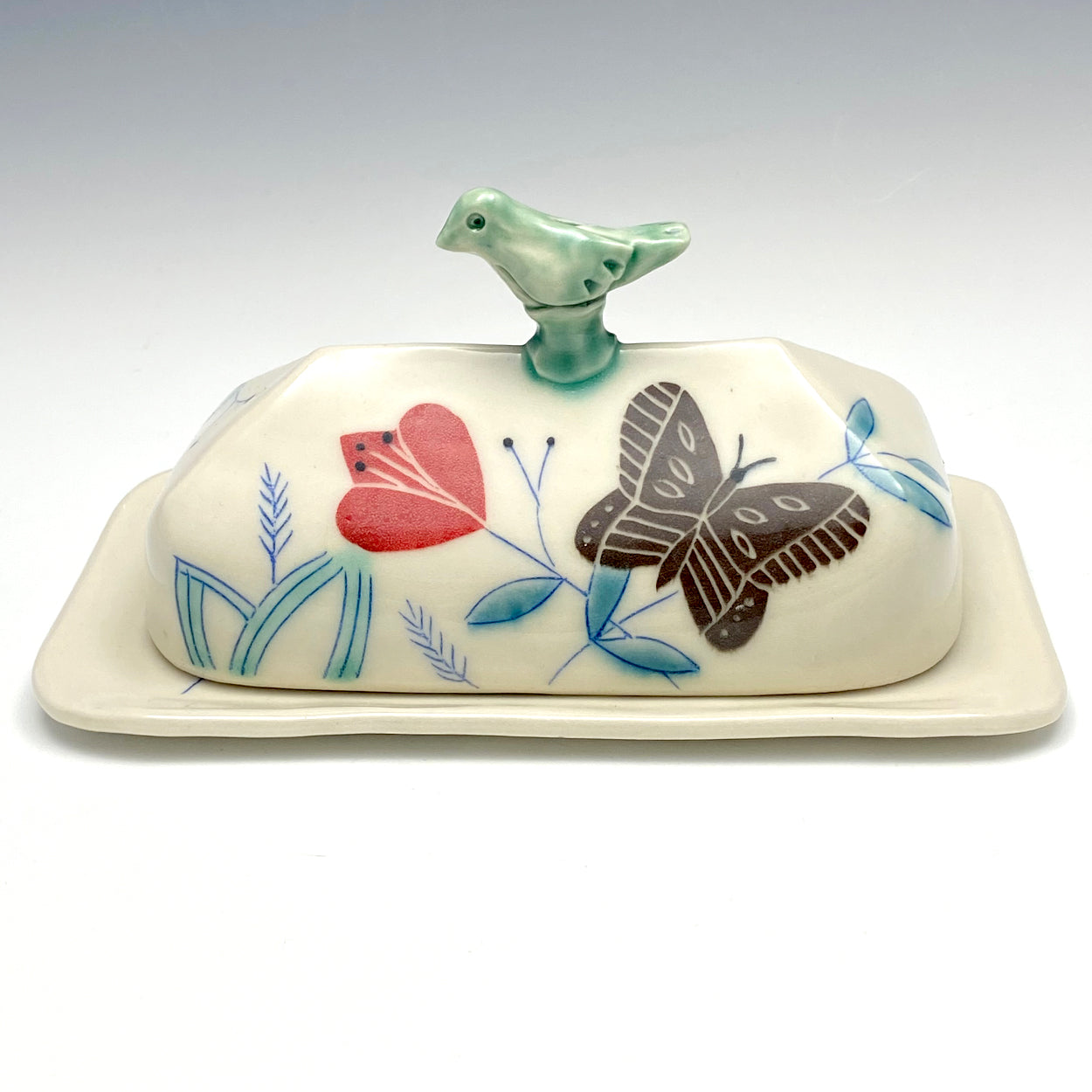 Butter dish with sculpted bird and brown butterflies