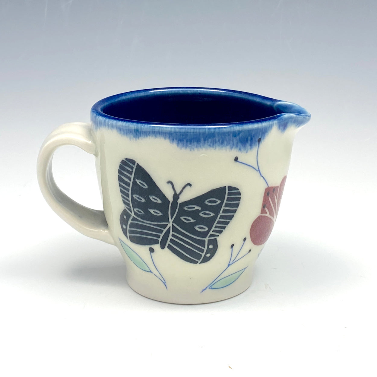 Creamer with black butterflies